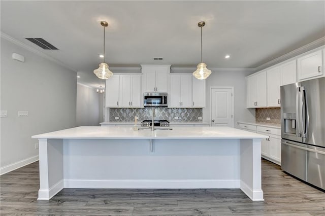 6270 Bracken Brown Dr, Alpharetta, GA 30004 - kitchen with appliances with stainless steel finishes, a spacious island, ornamental molding, light countertops, and backsplash