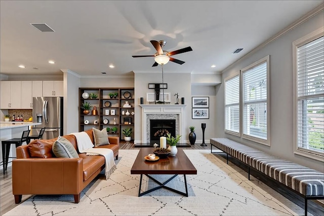 6270 Bracken Brown Dr, Alpharetta, GA 30004 - living area featuring ornamental molding, light wood-type flooring, a ceiling fan, a high end fireplace, and recessed lighting