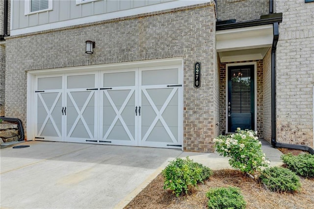 6270 Bracken Brown Dr, Alpharetta, GA 30004 - view of exterior entry with brick siding, board and batten siding, a garage, and concrete driveway