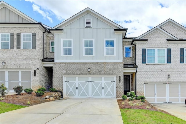 6270 Bracken Brown Dr, Alpharetta, GA 30004 - view of front of house with board and batten siding, an attached garage, driveway, and brick siding
