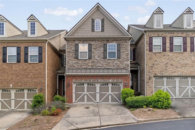 multi unit property featuring concrete driveway, brick siding, and an attached garage