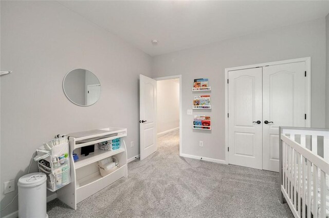 bedroom with a closet, baseboards, and carpet flooring
