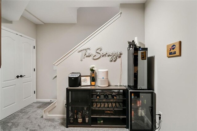 bar with carpet floors, baseboards, and wine cooler