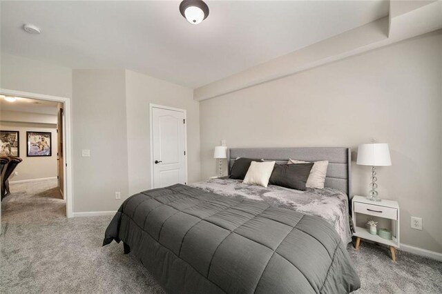 carpeted bedroom featuring baseboards