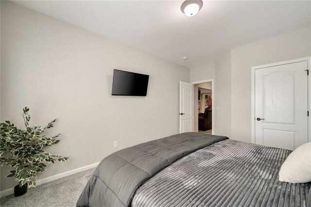 carpeted bedroom featuring baseboards