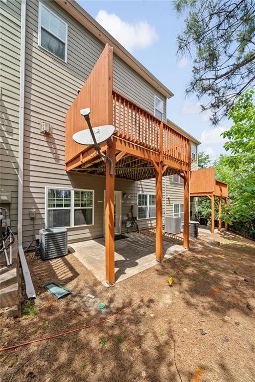 back of house with a patio, central AC, and a deck