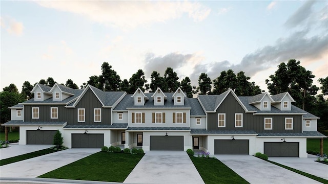 view of property featuring a front yard, driveway, an attached garage, board and batten siding, and a residential view