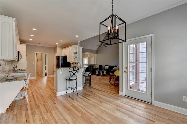 1901 Paper Birch Cv, Grayson, GA 30017 - kitchen with freestanding refrigerator, plenty of natural light, white cabinets, crown molding, and recessed lighting