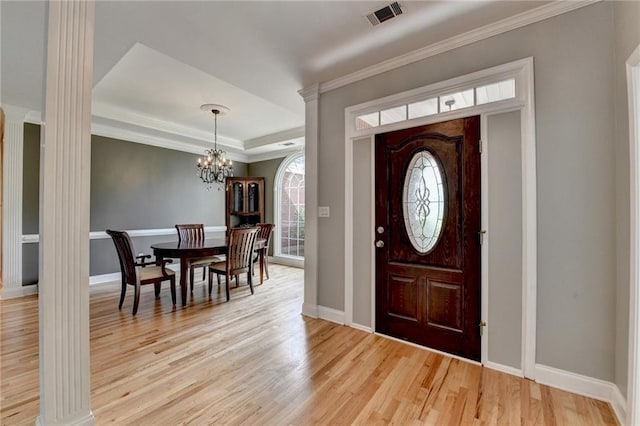 1901 Paper Birch Cv, Grayson, GA 30017 - foyer entrance featuring a chandelier, light wood-style floors, ornate columns, ornamental molding, and baseboards
