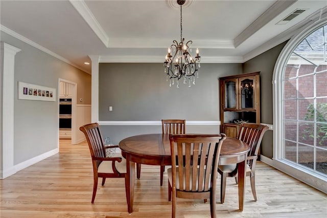 1901 Paper Birch Cv, Grayson, GA 30017 - dining space with light wood finished floors, a raised ceiling, a chandelier, ornamental molding, and baseboards