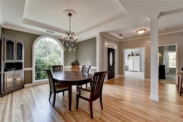 1901 Paper Birch Cv, Grayson, GA 30017 - dining room with decorative columns, light wood-style flooring, a chandelier, ornamental molding, and a raised ceiling