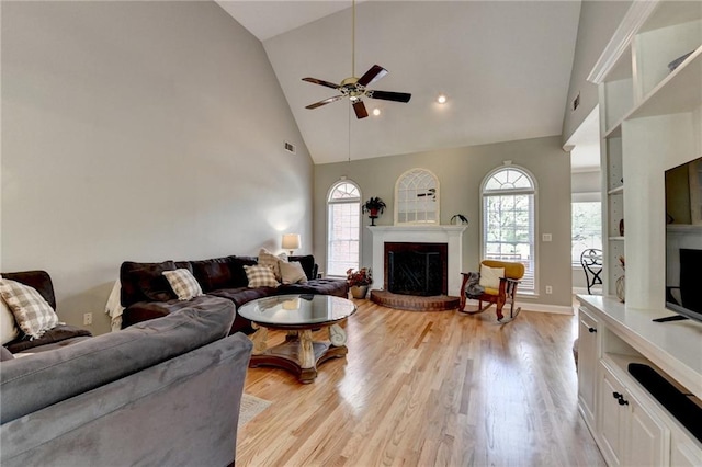 1901 Paper Birch Cv, Grayson, GA 30017 - living area with a fireplace, a ceiling fan, high vaulted ceiling, light wood-style flooring, and baseboards