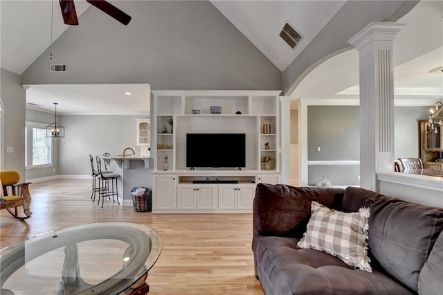 1901 Paper Birch Cv, Grayson, GA 30017 - living area featuring decorative columns, light wood-style flooring, ceiling fan, high vaulted ceiling, and a chandelier