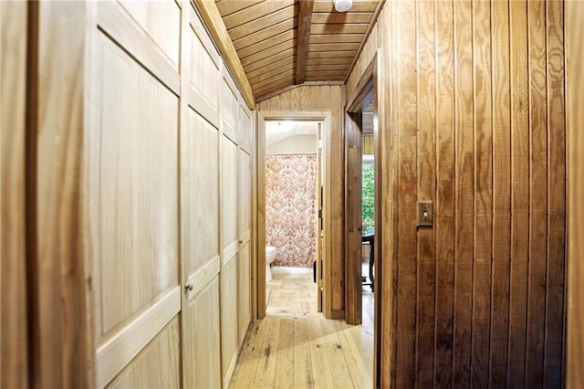 hallway with wooden ceiling, light wood finished floors, and lofted ceiling