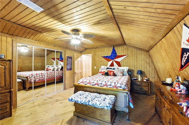 bedroom with wooden walls, lofted ceiling, wood ceiling, and wood-type flooring