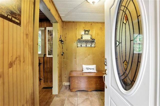 doorway featuring wooden walls
