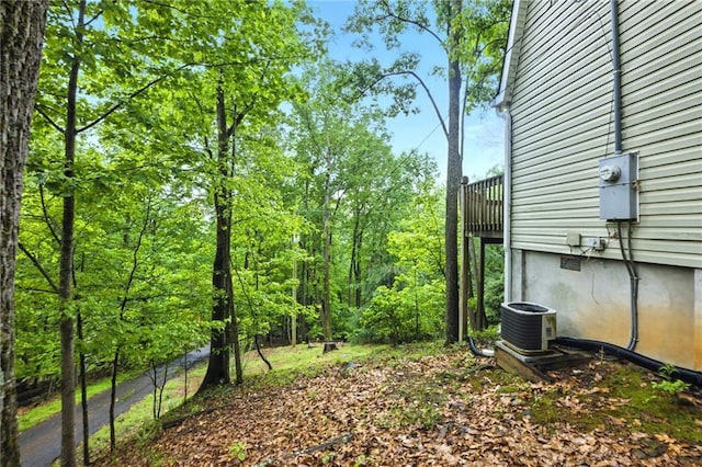 view of yard with cooling unit and a balcony