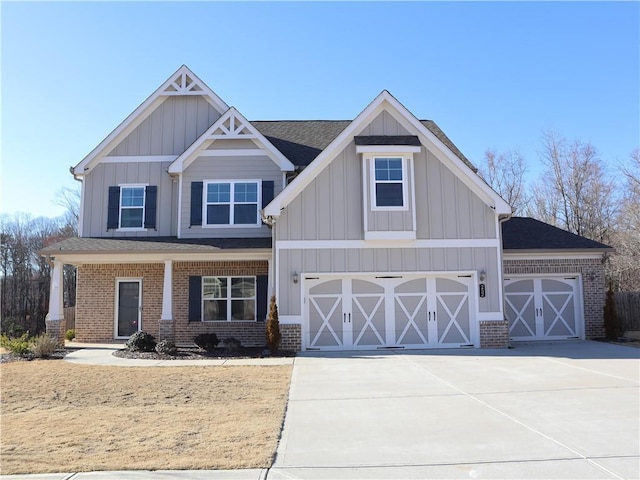 craftsman inspired home featuring concrete driveway, roof with shingles, board and batten siding, and brick siding