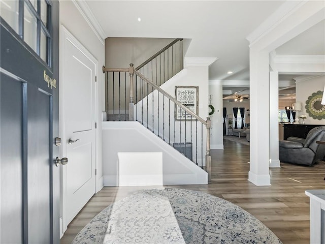 foyer entrance featuring a ceiling fan, ornamental molding, wood finished floors, stairs, and recessed lighting