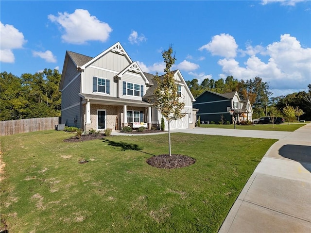 craftsman house with concrete driveway, fence, a front lawn, board and batten siding, and brick siding