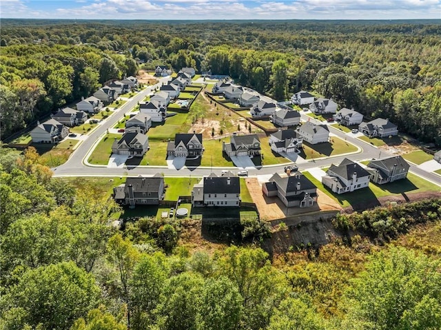 bird's eye view with a residential view and a wooded view