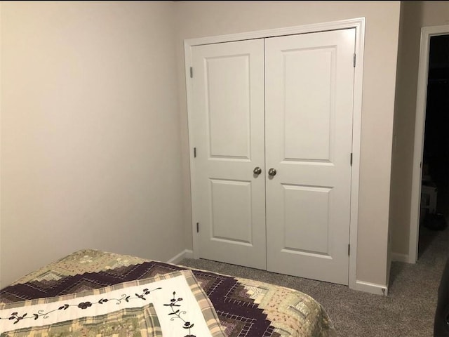 bedroom featuring dark carpet and a closet