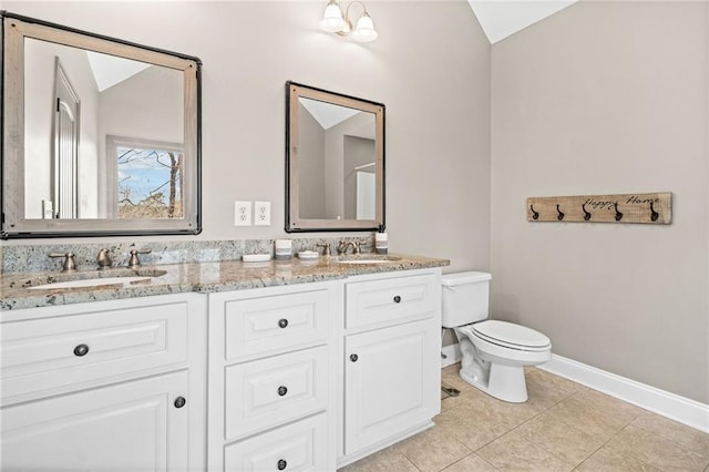 full bathroom with lofted ceiling, toilet, baseboards, double vanity, and tile patterned flooring