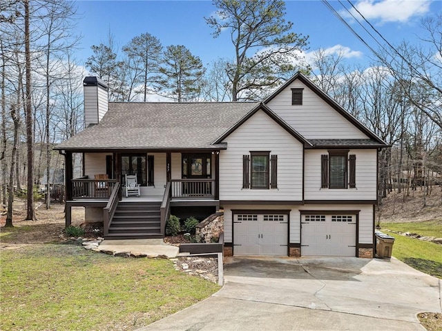 view of front of property with covered porch, an attached garage, a front lawn, concrete driveway, and a chimney