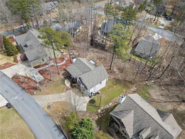 aerial view of property and surrounding area featuring nearby suburban area