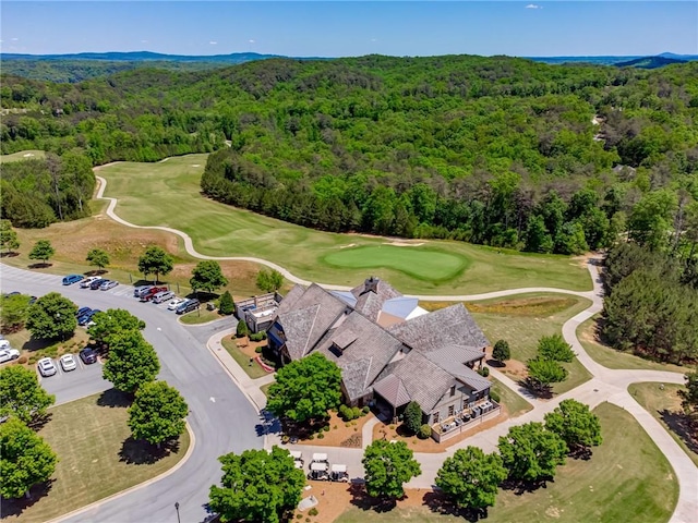drone / aerial view of a forest and a golf course