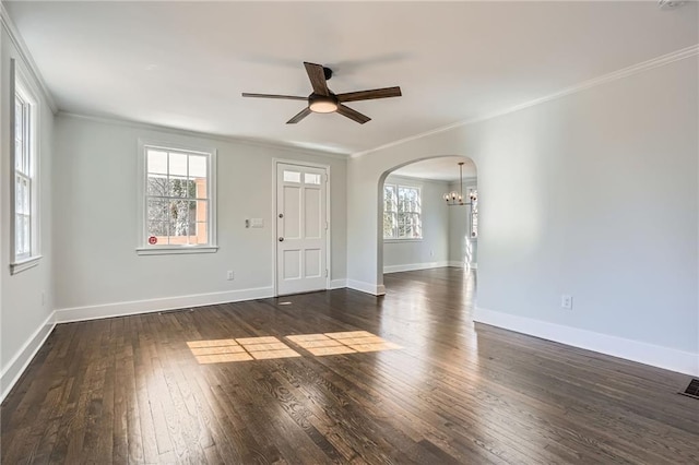 empty room featuring ceiling fan with notable chandelier, ornamental molding, and dark hardwood / wood-style floors