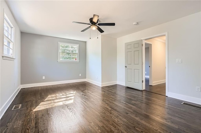 empty room with ceiling fan and dark hardwood / wood-style flooring