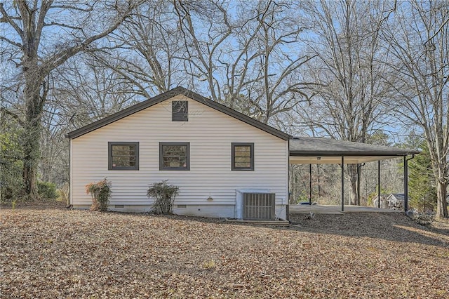 view of home's exterior with a carport and central air condition unit