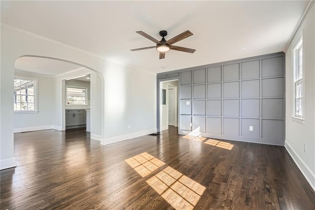 unfurnished room featuring ornamental molding, ceiling fan, and dark hardwood / wood-style flooring