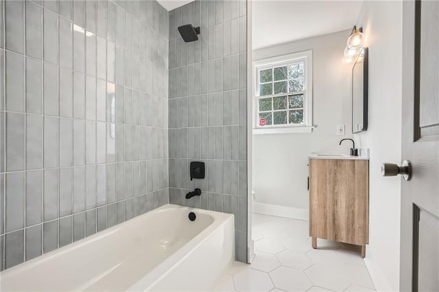 bathroom with tiled shower / bath, vanity, and tile patterned floors