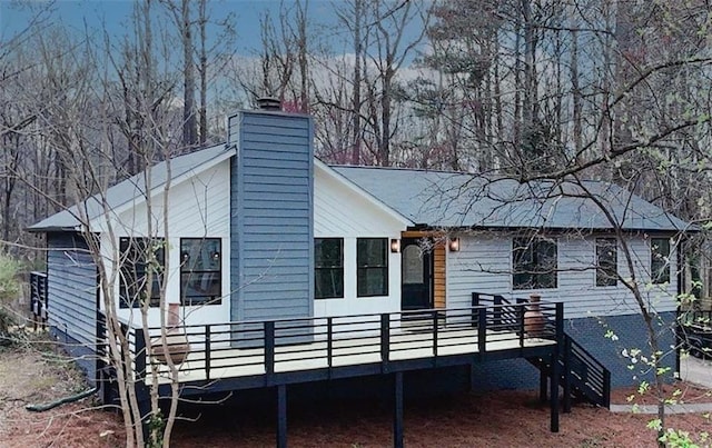 view of home's exterior featuring a deck and a chimney