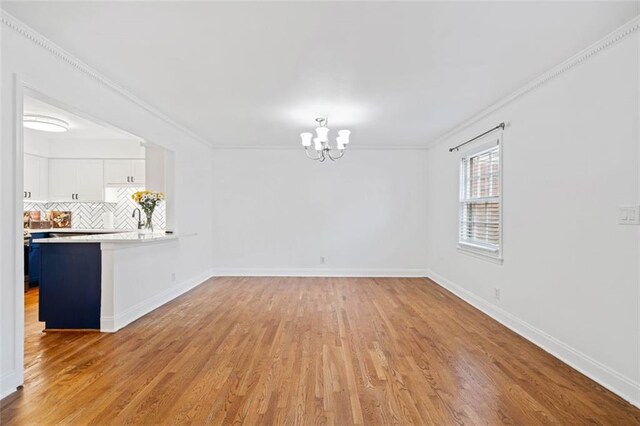 kitchen with white cabinetry, wood-type flooring, tasteful backsplash, and stainless steel refrigerator with ice dispenser