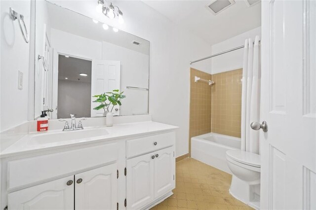 bathroom with tiled shower, vanity, and tile patterned flooring