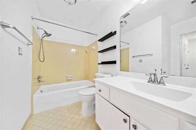 bathroom with tiled shower / bath combo, tile patterned floors, and ceiling fan