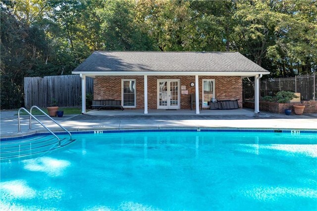 view of pool with an outdoor structure and a patio