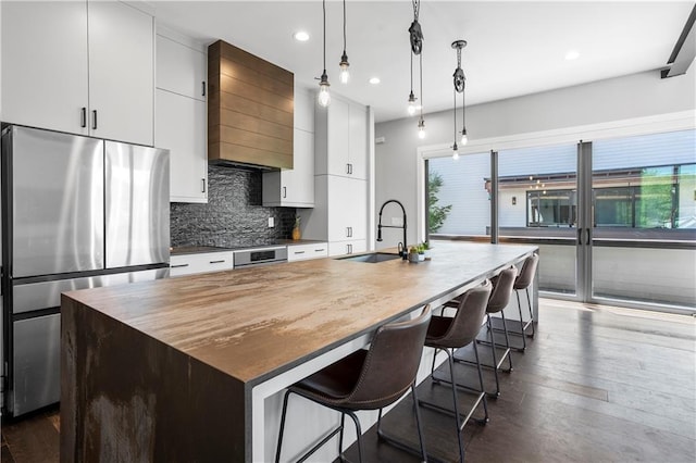 1331 Iverson St NE Unit A, Atlanta, GA 30307 - kitchen with a sink, freestanding refrigerator, custom range hood, a center island with sink, and backsplash
