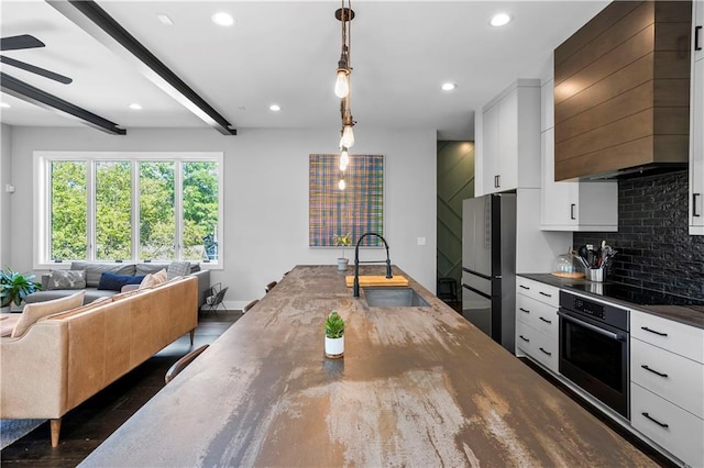 1331 Iverson St NE Unit A, Atlanta, GA 30307 - kitchen with appliances with stainless steel finishes, a sink, custom exhaust hood, open floor plan, and white cabinetry