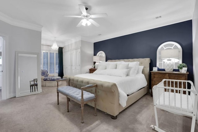 bedroom with a closet, visible vents, ornamental molding, a ceiling fan, and carpet flooring