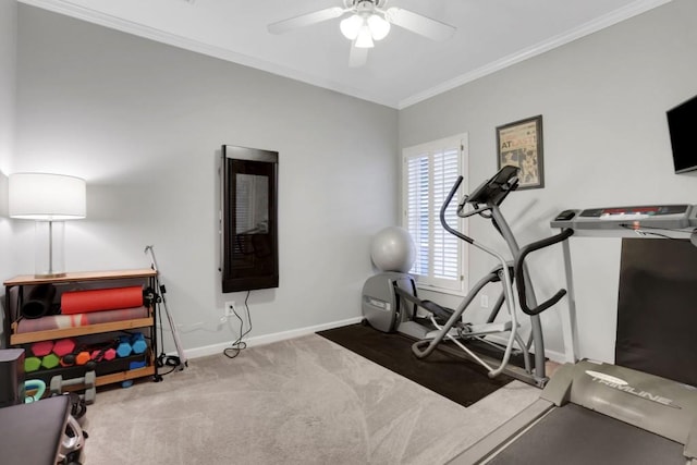 workout area with a ceiling fan, baseboards, ornamental molding, and carpet flooring