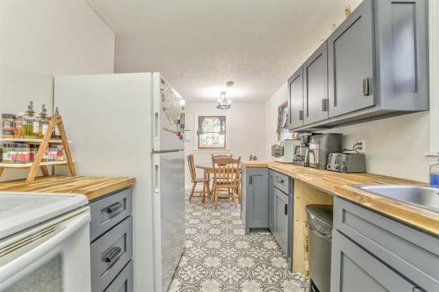 111 Sylvan Dr, Calhoun, GA 30701 - kitchen with gray cabinetry, wood counters, and white appliances