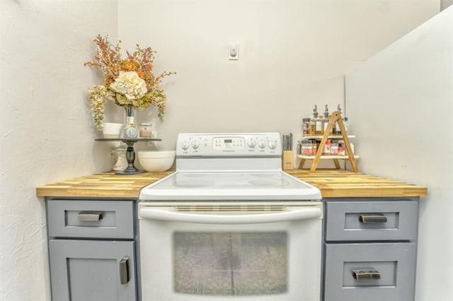 111 Sylvan Dr, Calhoun, GA 30701 - kitchen with white range with electric cooktop, gray cabinets, and butcher block countertops
