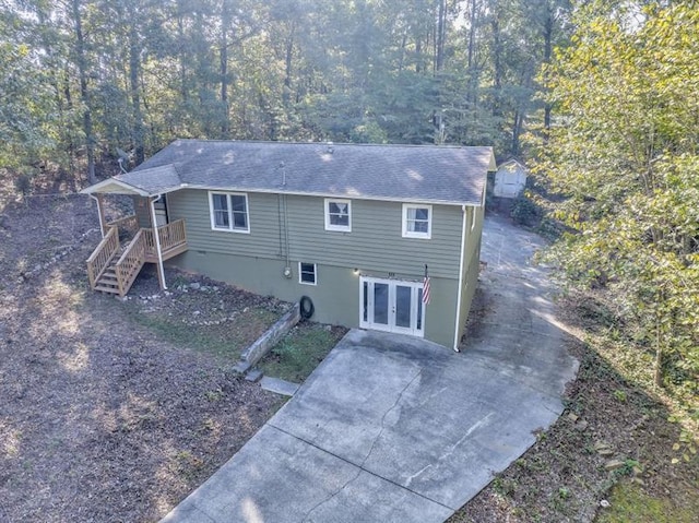 111 Sylvan Dr, Calhoun, GA 30701 - view of front of home with french doors, driveway, a wooded view, stairway, and a shingled roof