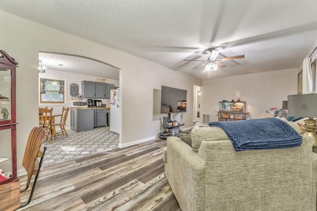 111 Sylvan Dr, Calhoun, GA 30701 - living room featuring arched walkways, ceiling fan, wood finished floors, and baseboards