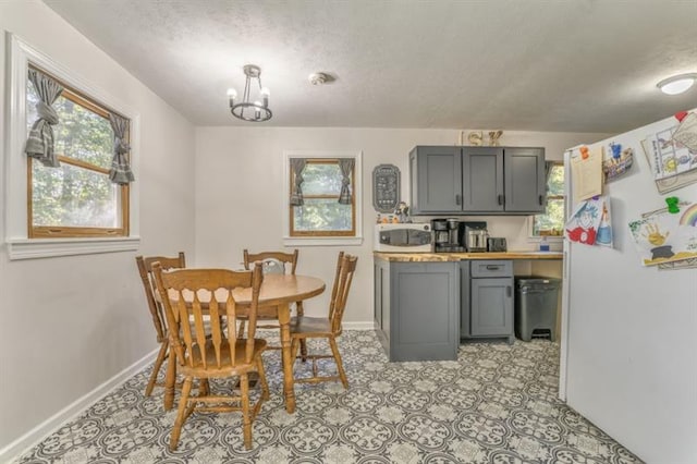 111 Sylvan Dr, Calhoun, GA 30701 - dining room with baseboards, a chandelier, and a textured ceiling