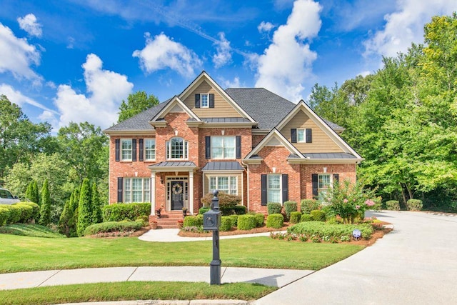 craftsman-style home featuring a front lawn